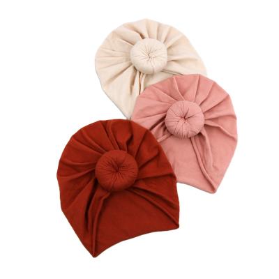 China Lovely Donut Image Baby Beanie Turban Solid Color Cotton Infant Donut Hair Accessories Girl Newborn Boy Hat for sale