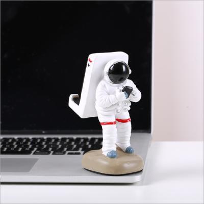 China New Trend China Astronaut Spaceman Mobile Phone Stand Creative Arts Resin Crafts Gift Home Decoration for sale