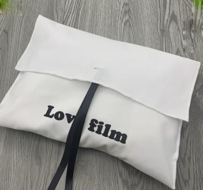 China Security Customize Logo Printed Suede Flap Wrap Bag Bowknot Suit Clothes Packaging Bag Pouch Custom Luxury Valentine Wedding Gift Bags for sale