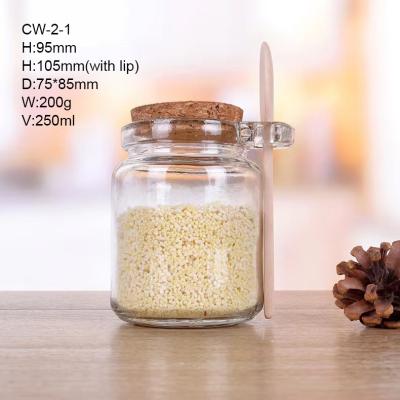 China Minimalist air jar tight clear glass bottles with wooden spoon and cork are used for kitchen storage containers for sale