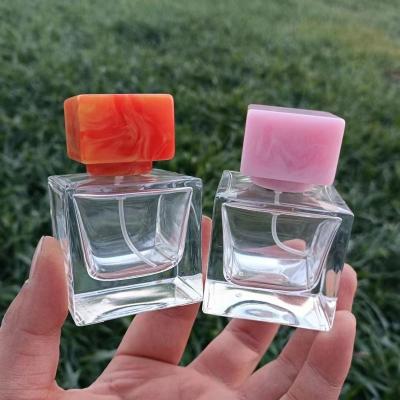 China Large Cube Glass Cosmetic Perfume Bottles Wholesalers With Resin Cap High Quality PUMP SPRAYER for sale