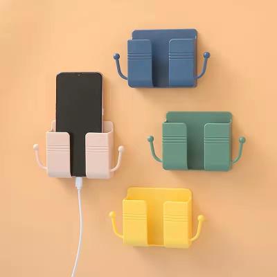 China 2021 Wholesale Multifunctional Mini Phone Holder For Wall Colorful Plastic Mount With Left Cell Phone Charging Accessories for sale