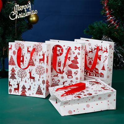 China New Design Recyclable Customized Logo Printed Cheap Packaging Paper Gift Bags Christmas Drawstring Gift Bags Happy Holidays Gift Bags for sale