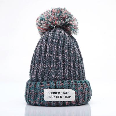 China Low MOQ New OEM style Korean winter pom pom beanie cuff plain plain hats with woven label for sale