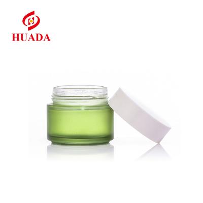 China 100g frosted glass cosmetic bottle manufacturer customized skin care crema jar transparent frosted green glass bottles wholesale for sale