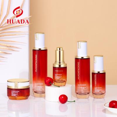 China Cosmetic Skin Care Products Packaging Glass Bottle Red Transparent Cosmetics Gradient Series Cream Bottle Set Perfume Bottle for sale