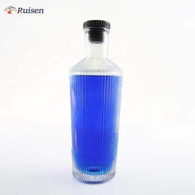 China Custom Unique Vertical Beverage Texure Glass Bottle 700ml Round Round Vodka Liquor Bottle With Polymer Cap for sale