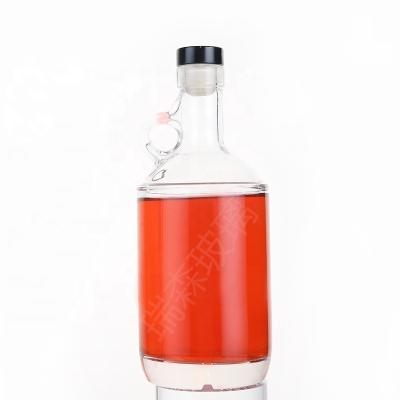 China 700ml glass unique shaped beverage bottle 750ml liquor glass bottle handle special whiskey bottle for sale