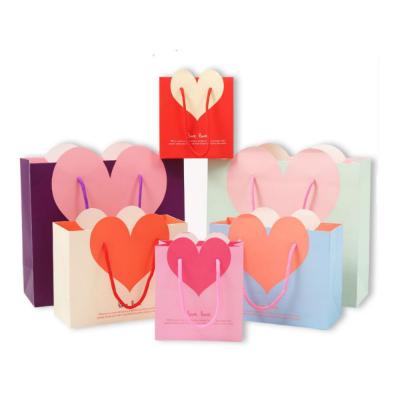 China Recycled Materials Wholesale Customization Heart Pattern Bag Packaging Folding Paper Bag Handling Gift Bag For Candy Cookie Jewelry for sale