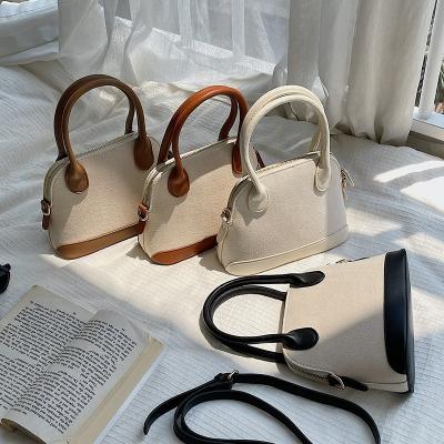 China Japanese 2021 new fashion and creative design handbag PU splicing single shoulder cross - body bag leisure canvas shell bag for sale