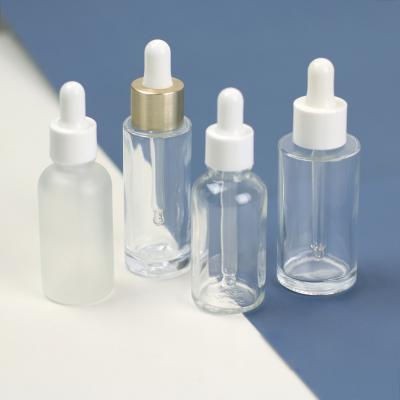 China High Quality Logo Clear Glass Dropper Bottle Metal Cosmetic Liquid Cap Custom Packing Serum Bottle for sale