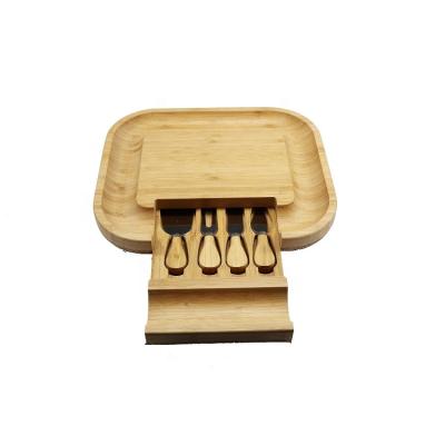 China Sustainable Natural Bamboo Cheese Board With 4 Piece Knife Tools Cutlery Set With Slide-out Drawer for sale