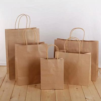 China New Logo Hot Foiled Stamping Black Matt Kraft Paper Bag With Gold Recyclable Cotton Rope Handles for sale