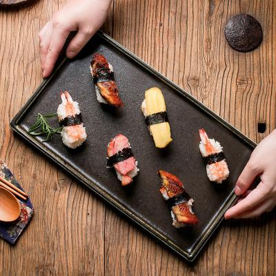 China 12 Inch Japanese Restaurant Rectangle Serving Ceramic Reactive Wholesale Viable Black BBQ Dish Hotel Porcelain Sushi Dinner Dishes for sale