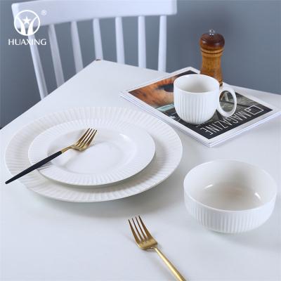 China Viable Wholesale Restaurant Round White Table Serving Dish Pure White Embossed Porcelain Dinnerware Sets for sale