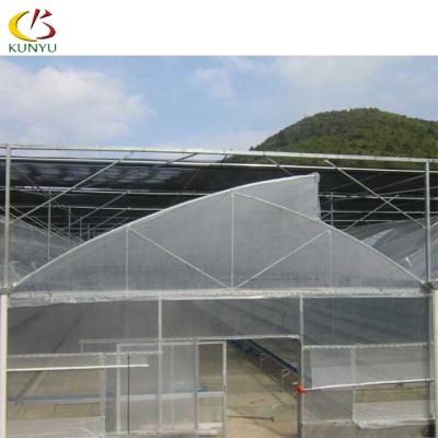 China Foshan Kunyu Low Cost PE Multi Span Sawtooth Shape PE Film Cover Plastic Sheet Greenhouse for sale