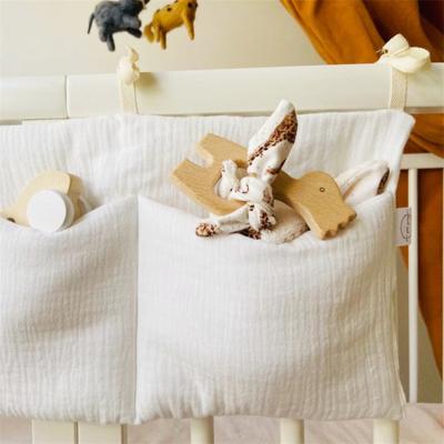 China Eco-Friendly Newborn Baby Muslin Cotton Toddler Crib Two Pockets Crib Organizer Hanging Storage Bag for Infant Diaper Teether Toys for sale