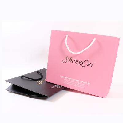 China Wholesale Recyclable Custom Logo Silver Hot Stamping Pink Apparel Shopping Wedding Paper Bags for sale