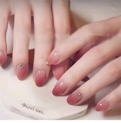 China Easy To Used 24Pcs Pink Gradient Fake Nails Short Pearl Oval Decoration Nail Removal Luminous False Nail Portable Manicure Tools for sale