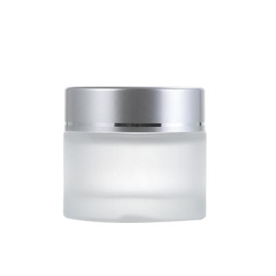 China Viable Manufacturer Wholesale Frosted Cosmetic Glass Jar With Silver Lid For Face Cream for sale