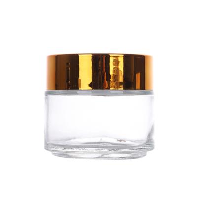 China Sustainable Low Price Round Shape Skin Care Packaging Bottles Clear Glass Jar For Face Cream for sale