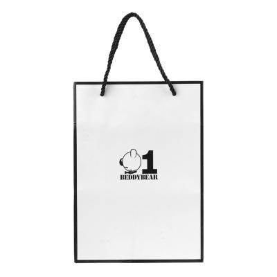 China Manufacturer High Quality Printed 250g Handmade Garment Paper Bag with Logo Print for sale