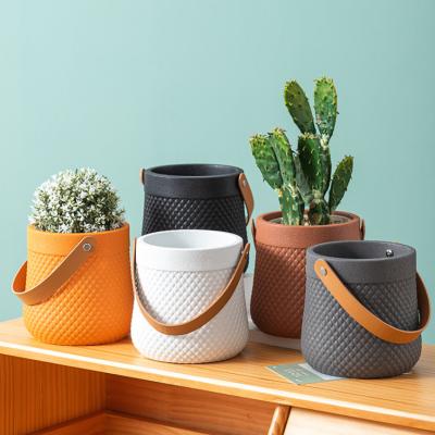 China Nordic Wholesale Modern Minimalist Flower Pots Cement Handbag Pots Indoor Plant Pots for sale