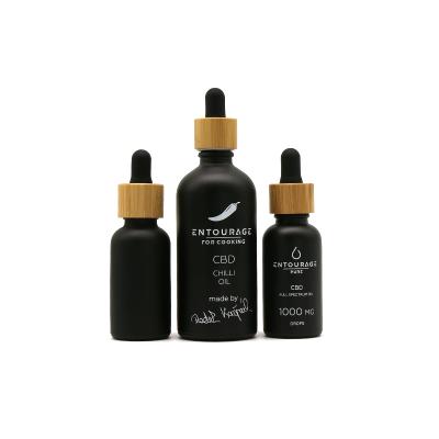 China Custom Printing Matte Black Cosmetic Packing 10ml 30ml 50ml Personal Care Round Shape Essential Oil Glass Bottle With Bamboo Cap for sale