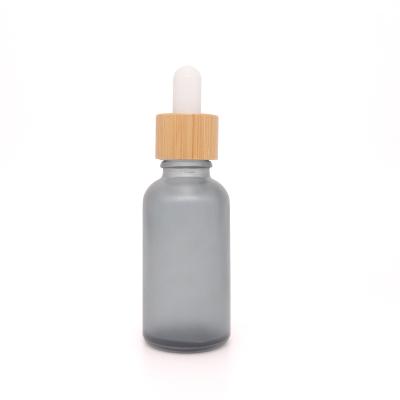 China Personal Care 1oz 30ml 50ml 100ml Frosted Black Glass Dropper Bottle With Bamboo Lid for sale