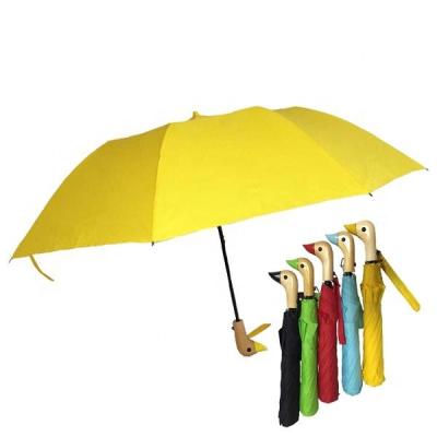 China Logo Printing Customized Yellow Foldable Strong Windproof Shape Automatic 2 Fold Outdoor Umbrella With Wooden Duck Handle for sale