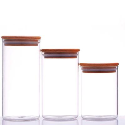 China Wholesale Clear Heat Resistant Glass Home Decoration Candle Jars With Wooden Lid for sale