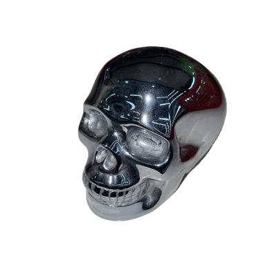 China Wholesale High Quality Natural Jiangsu Titanium Hertz Skulls Hand Carved Hematite Skulls Stone for sale