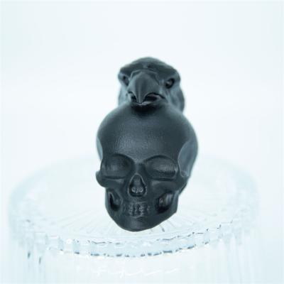 China China Wholesale Hand Carved Natural Gemstone Black Obsidian Crystal Skulls With Raven Animal Crow for sale