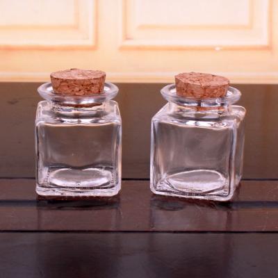 China Fancy 50ml Food Grade Small Empty Square Clear Glass Storage Jar Food Spice Honey Bottle With Wooden Cork Lids for sale