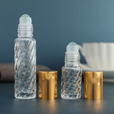 China 5ml 10ml Cosmetic Refillable Empty Clear Glass Roll On Essential Oil Bottles Glass Roll On Perfume Bottle With Rollerball And Gold Cap for sale