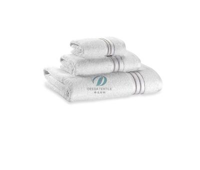 China Deeda factory logo hotel bath linen frequrent white 100% cotton embossed towels wash outfit for sale