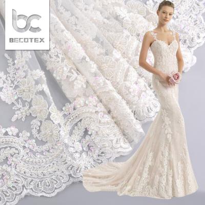 China Next New Anti-static Heavy White Luxury Hand Beaded Bridal Lace Fabric For Wedding for sale