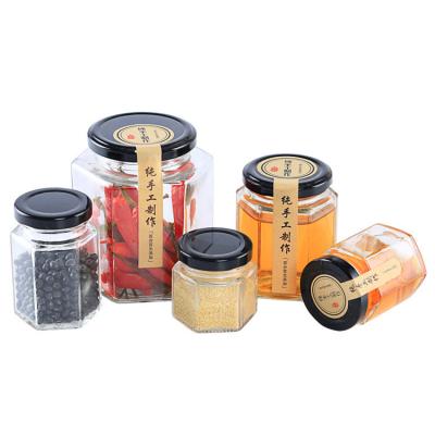 China 6oz 180ml Eco-friendly High Quality Jam Shape Hexagon Shape Bottles Storage Glass Jar Of Honey With Mental Black Lids for sale