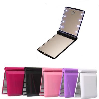 China Portable Handheld Lighted Touch Switch LED Lighted Makeup Mirror with 8 Dimmable Led Lights for sale