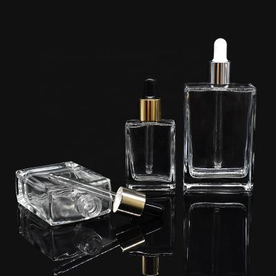 China Eco-friendly In Stock Dropper Bottle 30ml 50ml 100ml Rectangle Glass Cosmetic Glass Bottle With Glass Dropper for sale