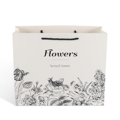 China Recyclable Eco Friendly Luxury White Kraft Paper Craft Cardboard Paper Shopping Bag With Printed Logo for sale