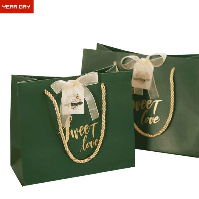 China Recycled materials clothing packaging paper bags customized LOGO birthday gifts corporate cofskin handheld shopping bags for sale