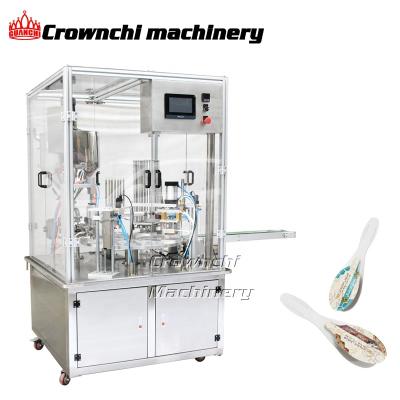 China Rotary Spoon Sealing Machine Honey Food Spoon Filling Honey Packing Machine With Cover for sale