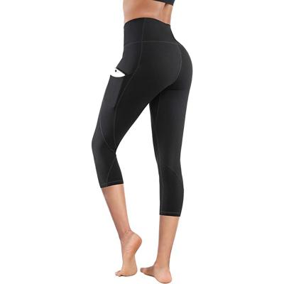 China Breathable Womens High Waist Yoga Pants With Pockets Tummy Control Sees Non Workout Sports Running Capri Leggings for sale