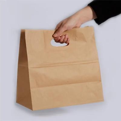 China Eco Friendly Customized Kraft Retail Die Cut Handle Shopping Paper Bags for sale