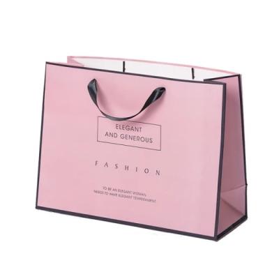 China Custom Logo Printed Pink Kraft Paper Gift Ribbon Handle Paper Bag For Shopping for sale