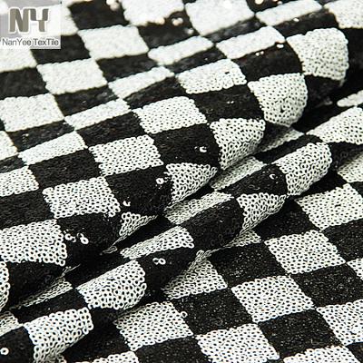 China Nanyee Sequin Textile 3mm Sequin Check Pattern Fluorescent Black And White Sequin Fabric for sale