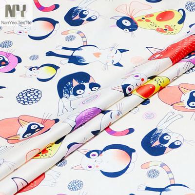 China Nanyee Hot Selling Cute Cat Printed Polyester Fabric Fluorescent Textile for sale