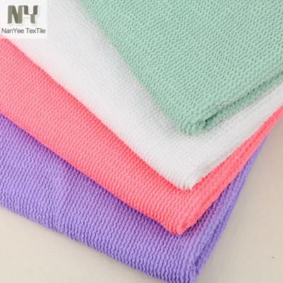 China Nanyee Textile Fluorescent Heavyweight Knitted Jacquard 4 Way Stretch Polyester Cotton Seersucker Fabric For Swimwear for sale