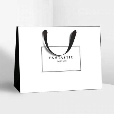 China Handmade Simple Style Black Paper Tote Bag Custom Clothing Store Bags Gift Bag Luxury Hot Buying Stamping Process LOGO for sale